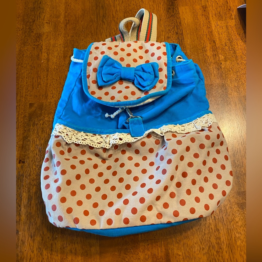 Cloth backpack. With polkadots and a bow.